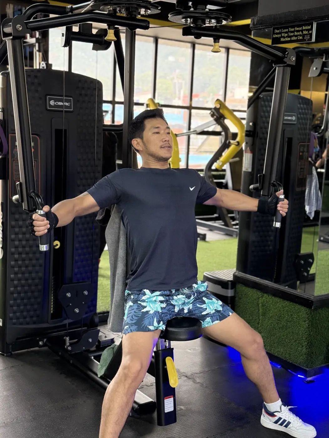 Member pressing through a chest fly on a selectorized machine